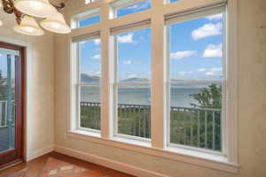 Dining room with a water view and wood finished floors