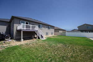 Rear view of house featuring stairway, a deck, and stucco siding