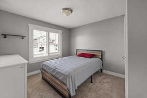 Carpeted bedroom with baseboards