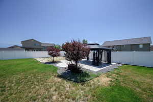 Fenced backyard with a gazebo and a patio