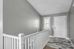 Entrance foyer featuring baseboards and wood finished floors