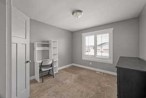 Unfurnished office with carpet and baseboards