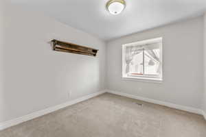 Spare room with carpet flooring and a textured ceiling