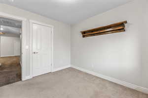 Unfurnished bedroom featuring carpet flooring and a textured ceiling