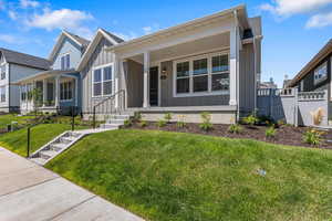 View of front facade with board and batten siding and a porch