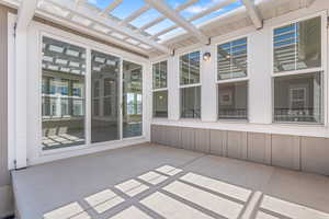Unfurnished sunroom featuring a skylight