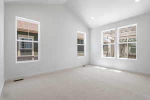 Unfurnished room with carpet floors, recessed lighting, and high vaulted ceiling