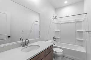 Full bath featuring vanity, bathtub / shower combination, and recessed lighting