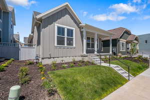 View of front of home with board and batten siding and a porch