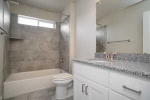 Bathroom with vanity and bathtub / shower combination