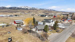 Aerial view of property's location with a mountainous background and nearby suburban area