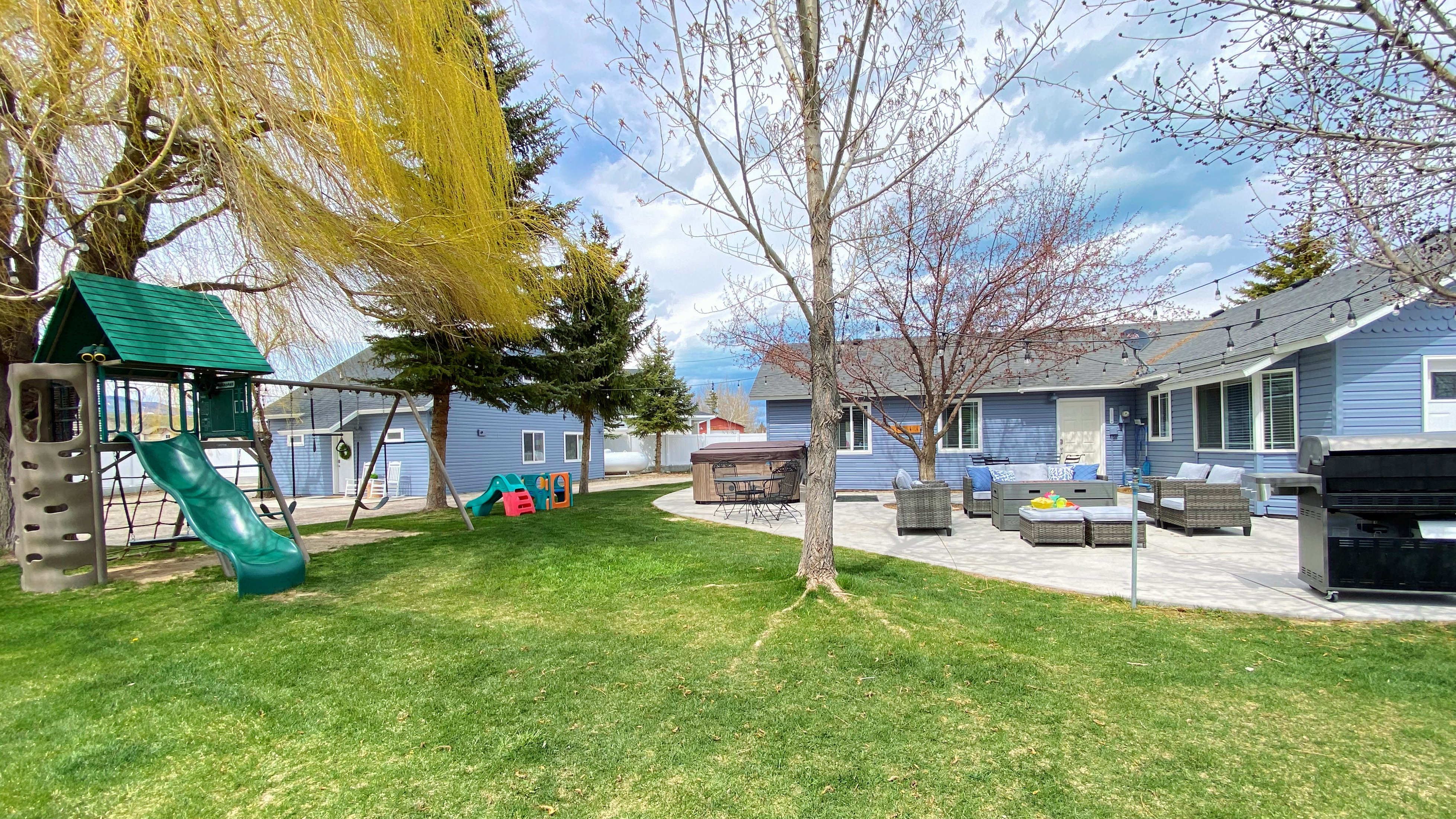 Fun playset and large patio for gathering beneath the large shade trees (when they are leafed out)