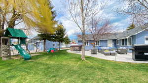 Fun playset and large patio for gathering beneath the large shade trees (when they are leafed out)