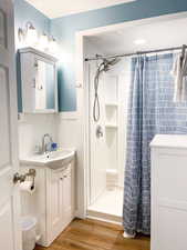 3/4 hall bathroom with hair dryer and plenty of bath towels