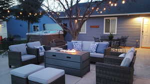 Outdoor seating with fire table and bistro lights