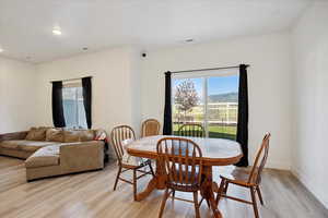 Dining room featuring healthy amount of natural light, recessed lighting, and light wood finished floors