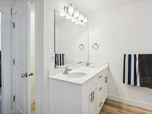 Primary Full bath with double vanity and wood finished floors
