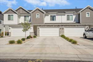 Craftsman-style home featuring stone siding, board and batten siding, and an attached garage