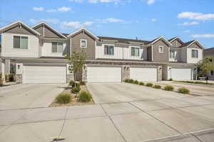 Craftsman-style house featuring stone siding, driveway, board and batten siding, and a garage