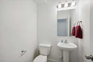 Half bath on the Mail level with toilet and a sink