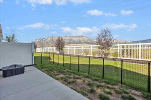Fenced backyard with a mountain view and a patio area
