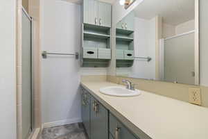 Full bath featuring vanity and a shower stall