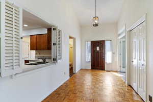 Foyer entrance with a chandelier and a towering ceiling