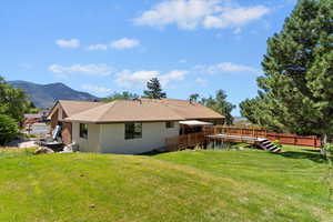 Back of house with a deck with mountain view