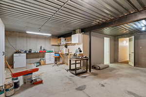 Unfinished below grade area featuring a workshop area