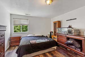 Bedroom with wood finished floors and baseboards