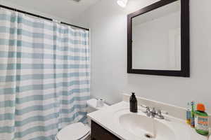 Bathroom with vanity and a shower with shower curtain