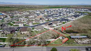 Aerial perspective of suburban area with property boundaries highlighted and a mountain backdrop