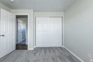Unfurnished bedroom featuring carpet floors and a closet