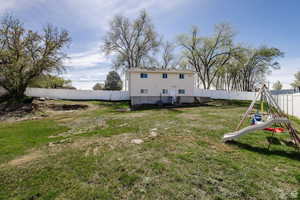 Fenced backyard with a playground