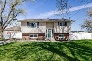 Raised ranch with entry steps and brick siding