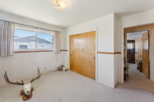 Unfurnished bedroom with carpet floors and a closet