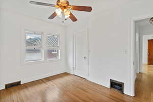 Unfurnished bedroom featuring light wood-type flooring and a ceiling fan