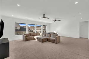 Living room featuring light carpet, recessed lighting, and ceiling fan