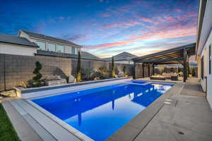 View of pool featuring outdoor lounge area, a fenced backyard, a gazebo, and a patio area