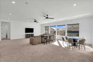 Living area with carpet floors, recessed lighting, and ceiling fan