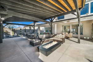 Fenced backyard with an outdoor living space with a fire pit, outdoor dining area, and a patio