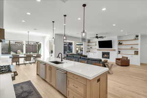 Kitchen featuring appliances with stainless steel finishes, light brown cabinets, a ceiling fan, light wood-type flooring, and recessed lighting