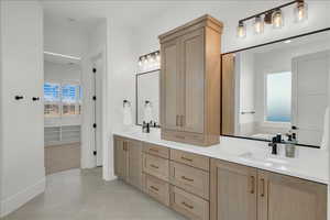 Bathroom with double vanity and tile patterned flooring