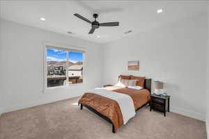 Bedroom with light carpet, recessed lighting, and a ceiling fan