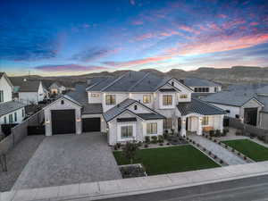 French country inspired facade featuring stone siding, decorative driveway, a standing seam roof, a metal roof, and a residential view