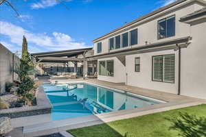 Back of house with outdoor lounge area, stucco siding, a fenced backyard, and a patio