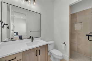 Ensuite bathroom with vanity and tiled shower
