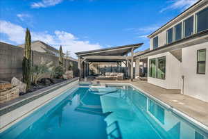 View of pool featuring outdoor lounge area, a fenced backyard, and a patio area