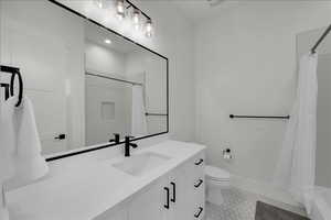 Full bathroom with vanity and toilet
