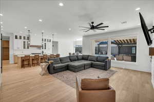 Living area with recessed lighting, light wood-style flooring, and ceiling fan